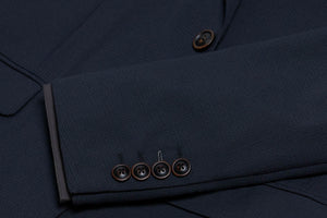 A close-up of wood buttons on a navy suit